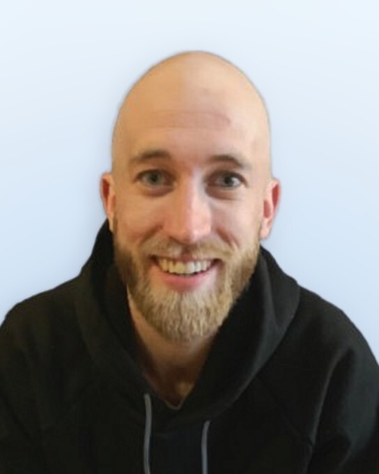 Zach, smiling, in a black hoodie